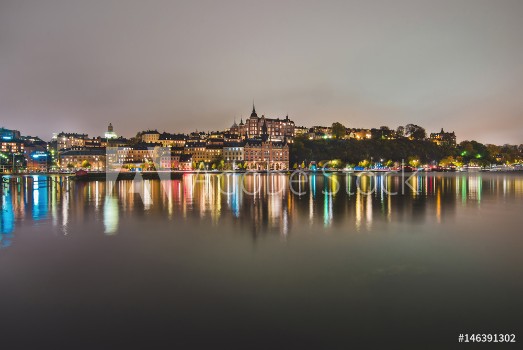 Picture of Stockholm city lights and night view of Sodermalm district buildings reflected in the water Evening Stockholm cityscape with illumination Riddarfjarden marina and Soder Malarstrand embankment